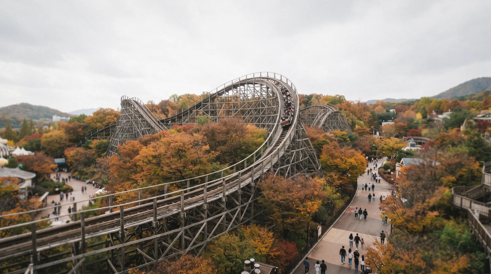 A wooden roller coaster track curving above trees at Everland near Seoul, South Korea