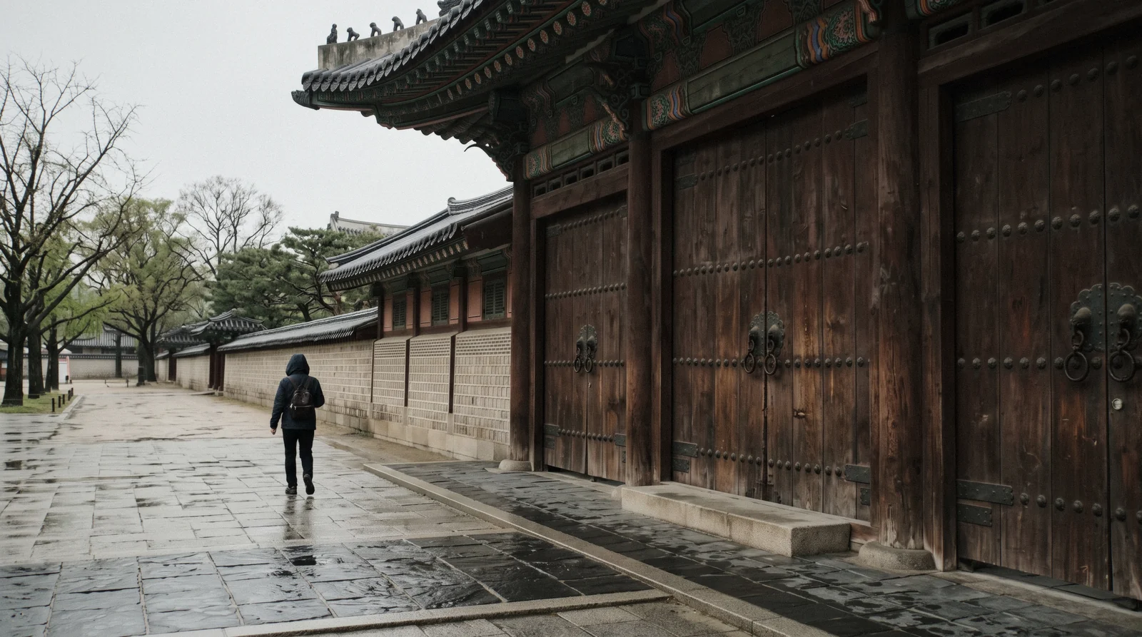 A closed wooden palace gate in central Seoul on a quiet weekday morning, Seoul, South Korea