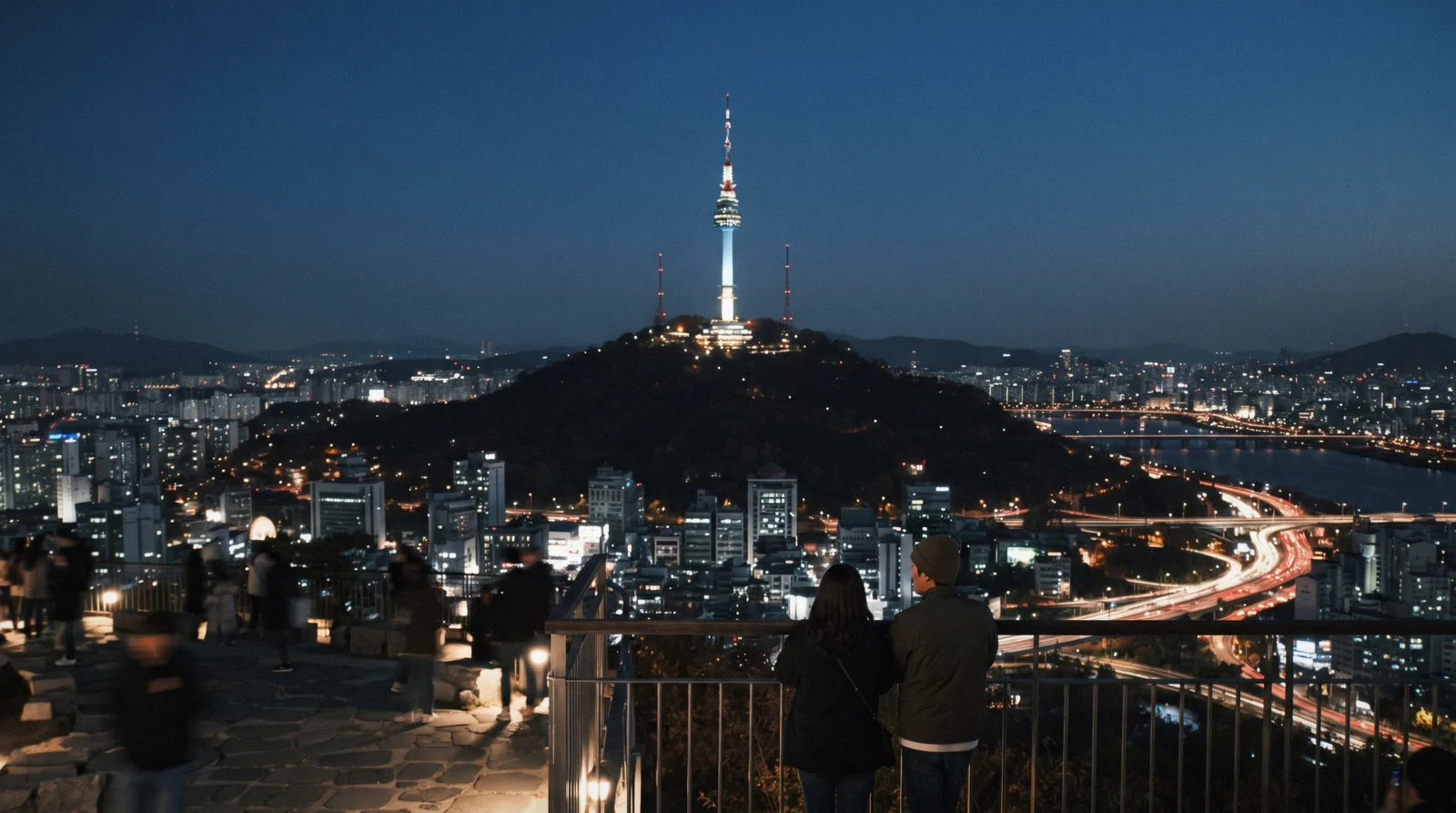N Seoul Tower lit above Namsan with the city and river spread out below at blue hour, Seoul, South Korea