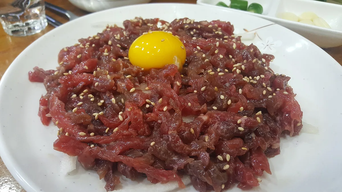 A plate of yukhoe raw beef at a Gwangjang Market counter, Seoul, South Korea